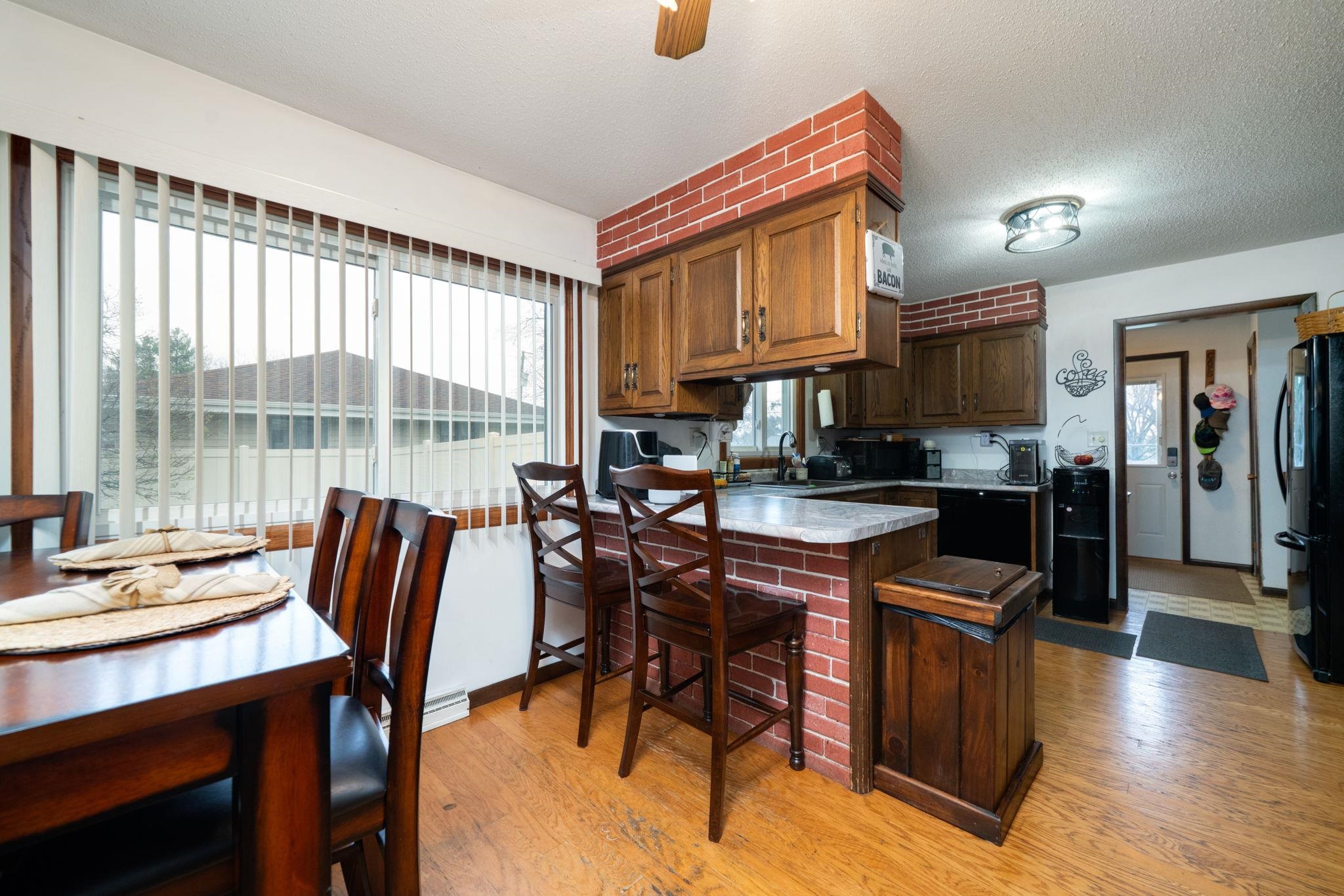109 13th Street Oregon, IL 61061 - Photo 20 of 44 a kitchen with stainless steel appliances granite countertop a table chairs and a refrigerator