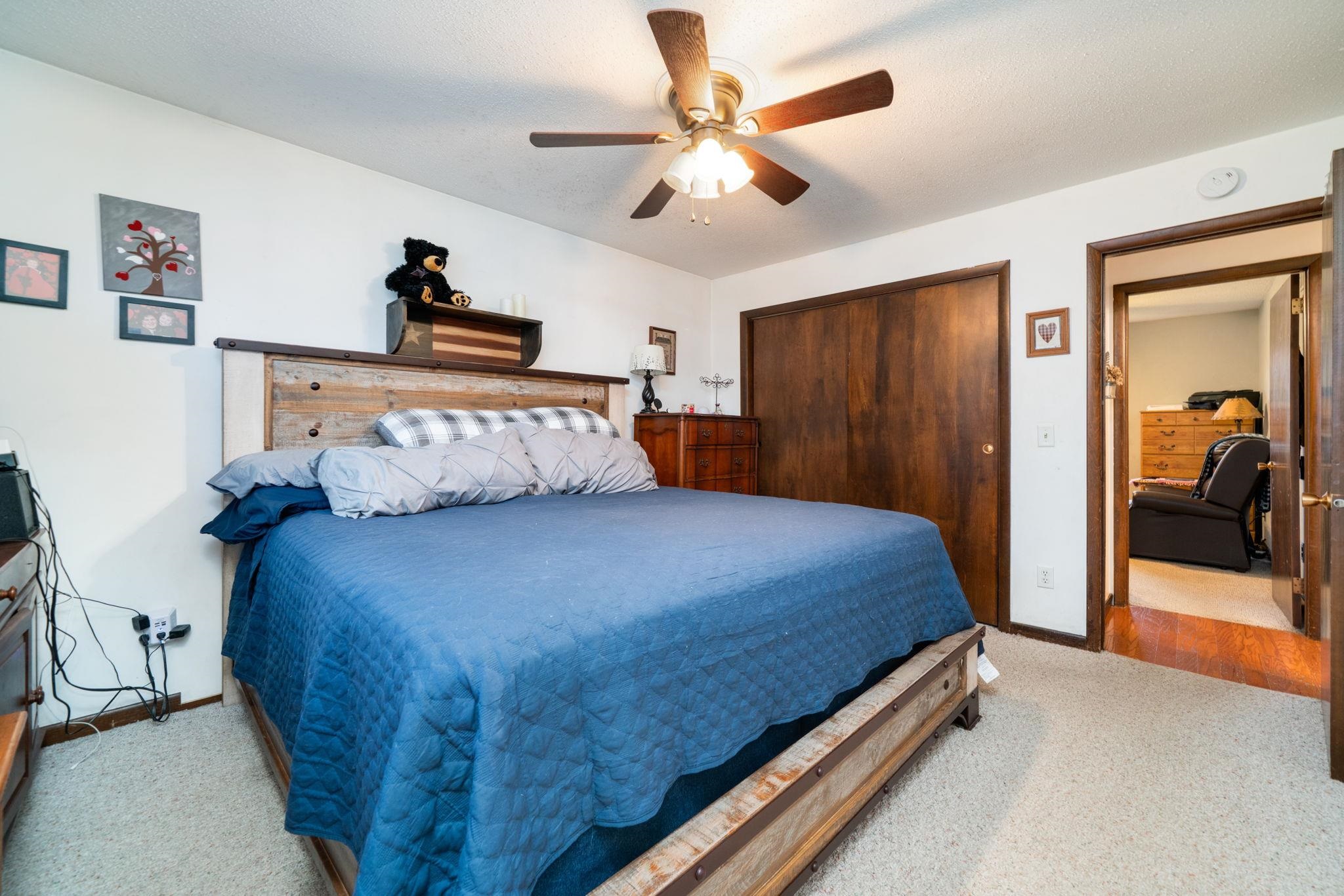 109 13th Street Oregon, IL 61061 - Photo 23 of 44 a bedroom with a large bed and a chandelier