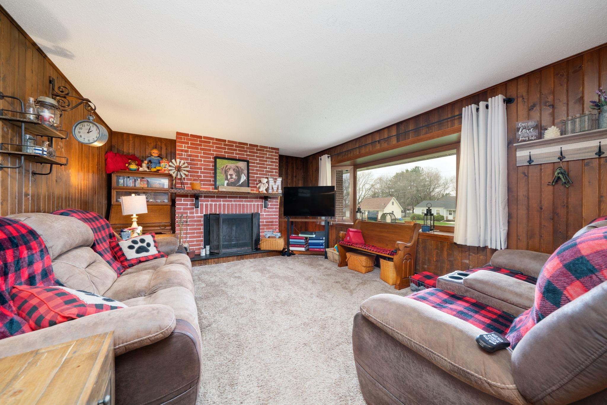 109 13th Street Oregon, IL 61061 - Photo 4 of 44 a living room with furniture a flat screen tv and a fireplace