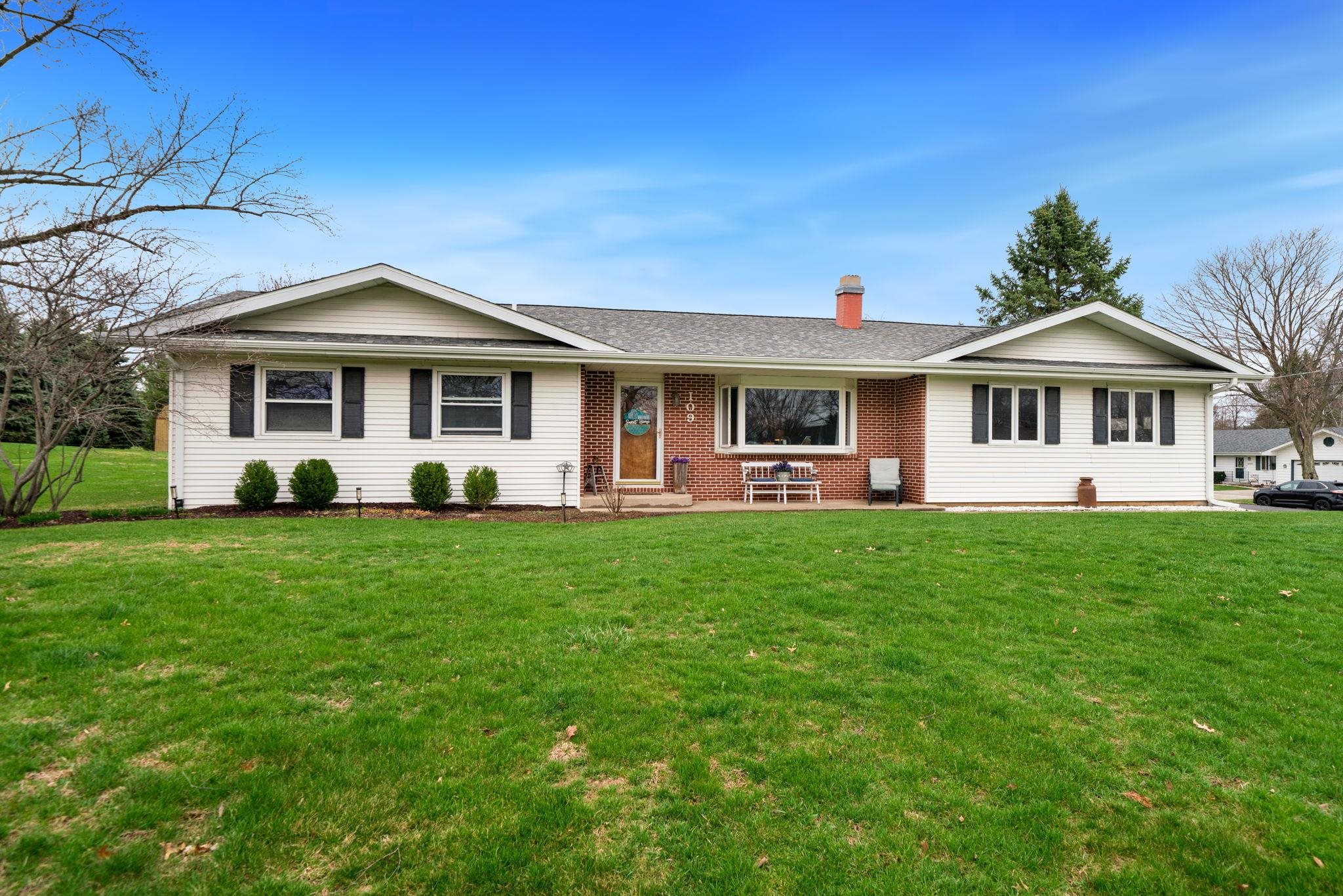 109 13th Street Oregon, IL 61061 - Photo 41 of 44 a front view of a house with a yard table and chairs