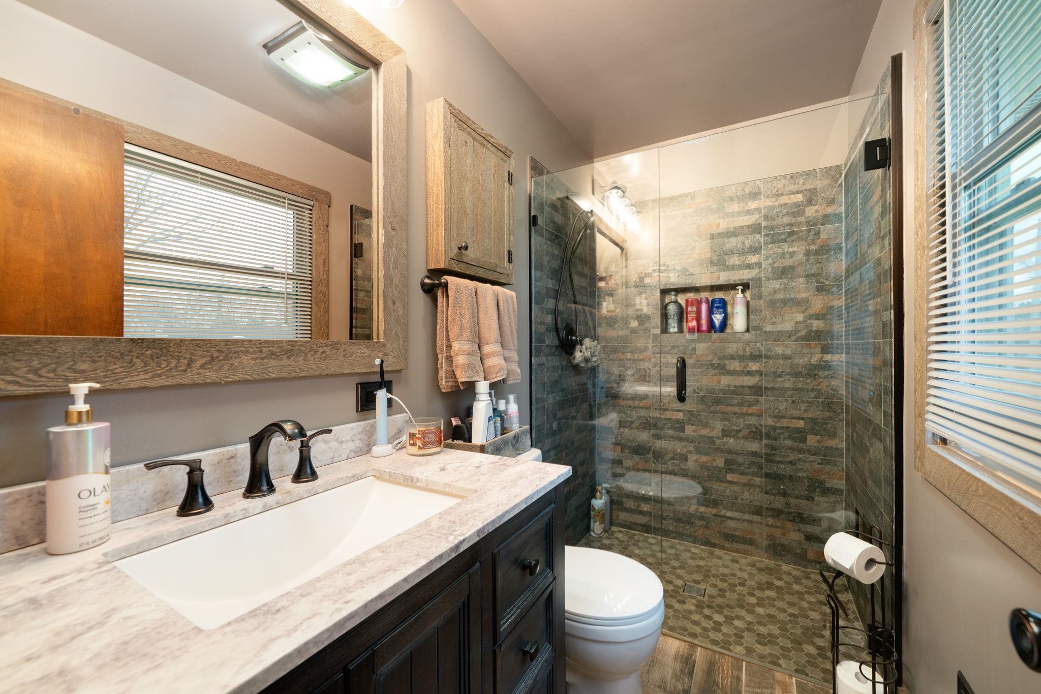 109 13th Street Oregon, IL 61061 - Photo 7 of 44 a bathroom with a granite countertop sink toilet and shower