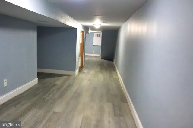 a view of hallway with wooden floor