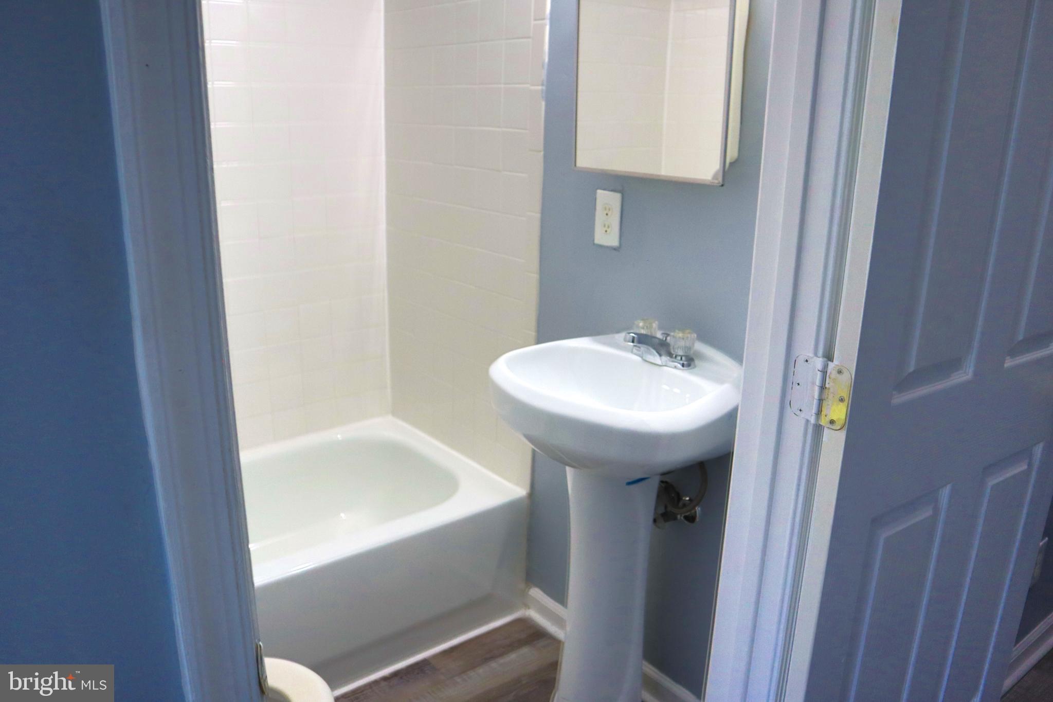 2011 Hollins Street Baltimore, MD 21223 - Photo 6 of 15 a bathroom with a sink and a bathtub