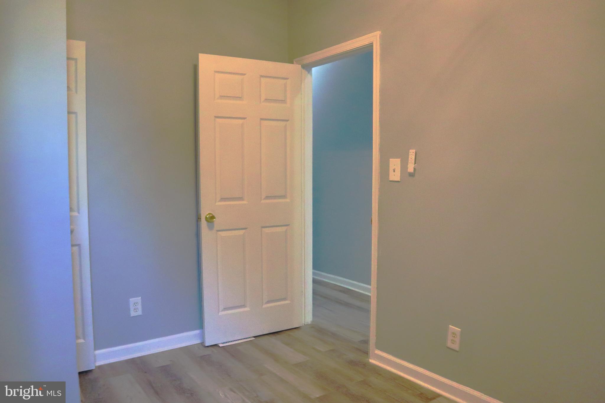 2011 Hollins Street Baltimore, MD 21223 - Photo 7 of 15 an empty room with wooden floor and closet