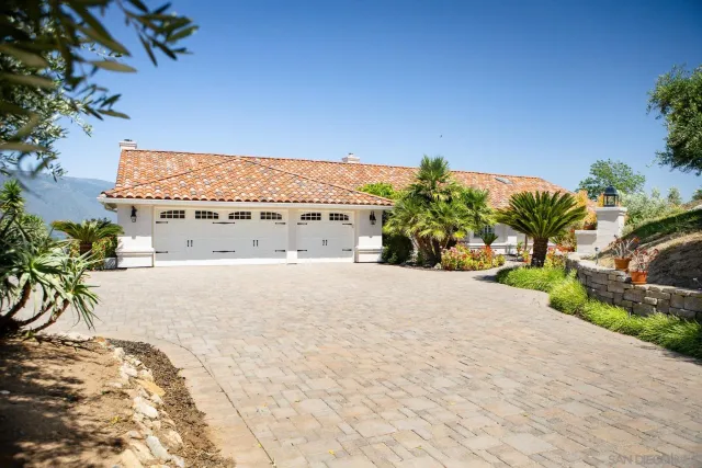 an aerial view of residential house and sandy dunes