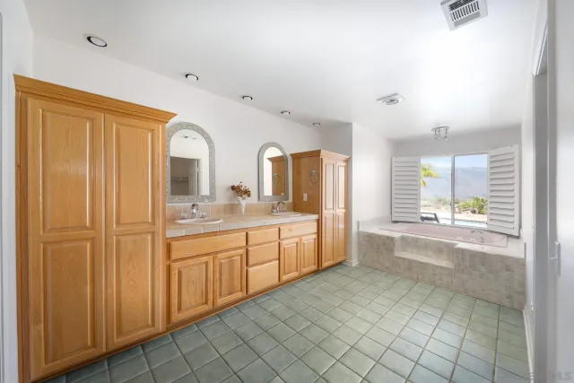 a spacious bathroom with a sink mirror and a bathtub