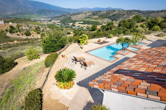 a view of a lake with a yard and a large tree