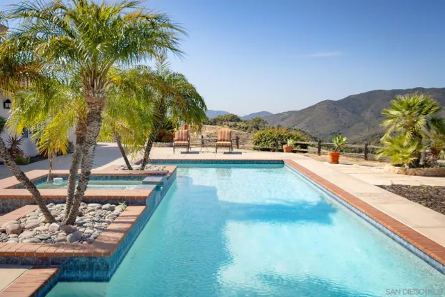 a view of swimming pool with a table and chairs