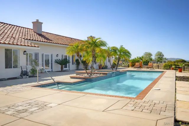 a swimming pool with outdoor seating