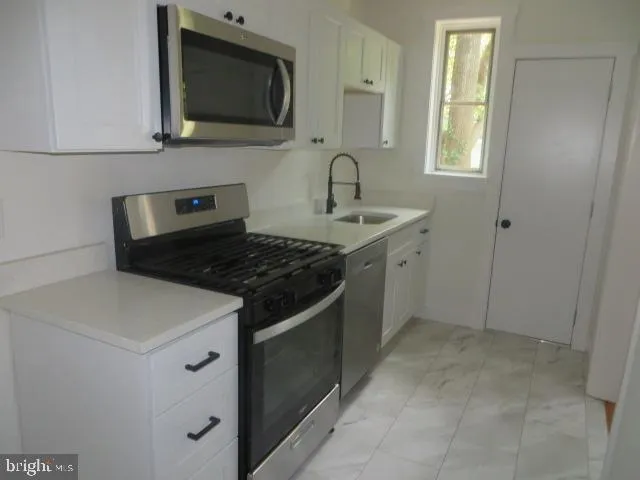 a kitchen with a stove and a microwave