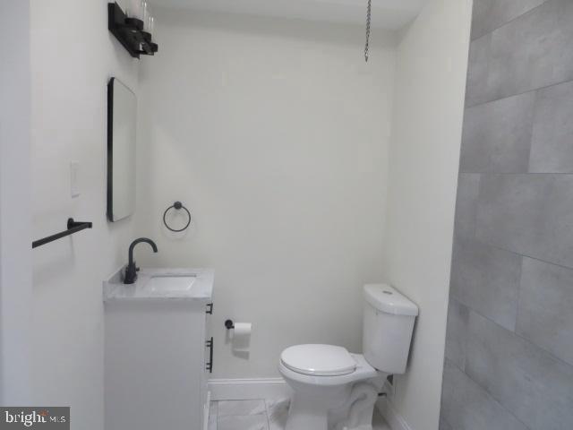 2617 Hobson Street Philadelphia, PA 19142 - Photo 12 of 14 a bathroom with a toilet sink and mirror