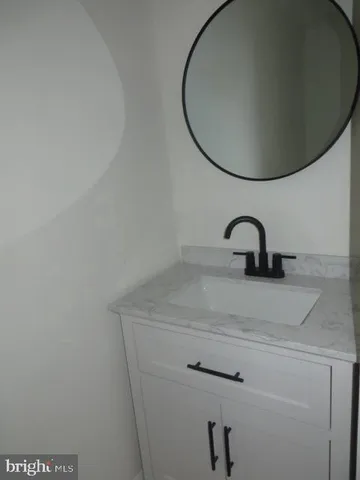 a close view of a sink a mirror and tap