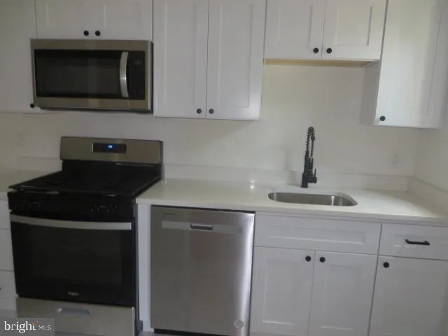 a kitchen with a stove and a microwave