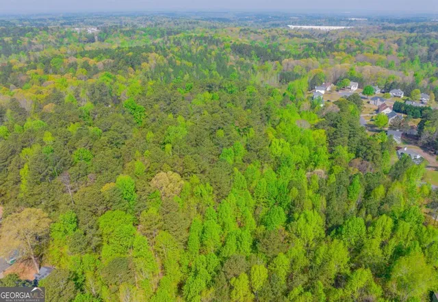 a view of a green field with lots of bushes