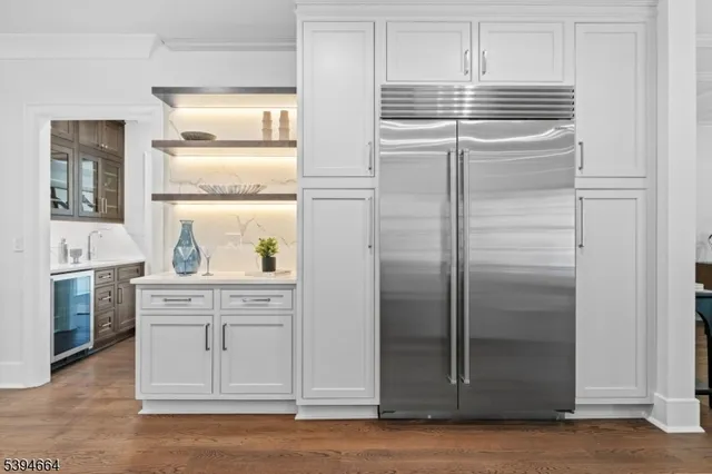a kitchen with stainless steel appliances cabinets and a window