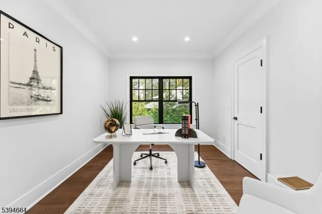 a workspace with wooden floor and a window