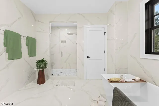 a bathroom with a tub sink and shower