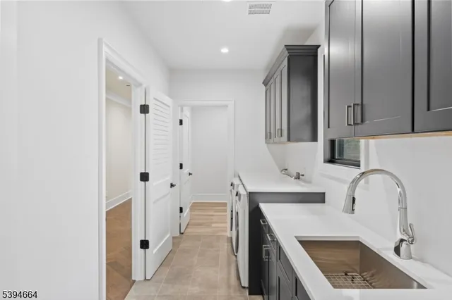 a kitchen with granite countertop a sink stainless steel appliances and cabinets