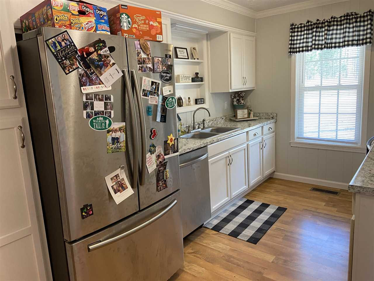 100 Montezuma Road Henderson, TN 38340 - Photo 9 of 20 a view of a kitchen with fridge and wooden floor