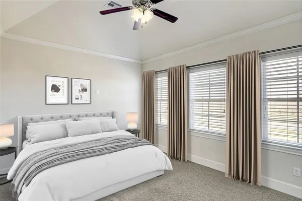 a bedroom with a large bed and a window