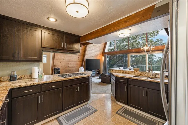 a kitchen with a sink and large window