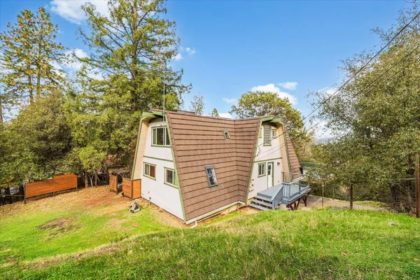 a view of backyard with wooden floor and outdoor seating