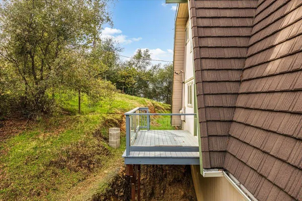 a view of balcony with wooden floor and fence