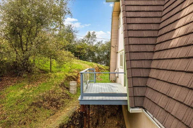 a view of balcony with wooden floor and fence