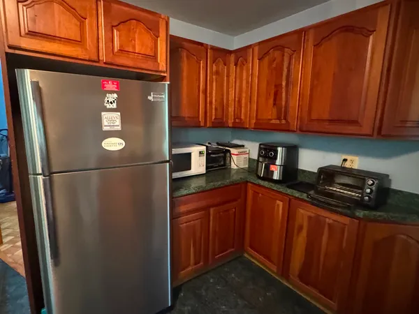 a kitchen with stainless steel appliances granite countertop a refrigerator and a sink
