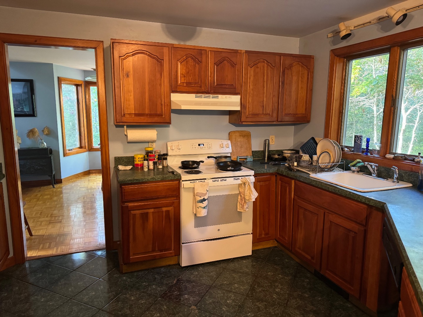 20 Brook Hollow Road West Tisbury, MA 02568 - Photo 14 of 33 a kitchen with stainless steel appliances granite countertop a stove a sink dishwasher and a microwave oven with cabinets