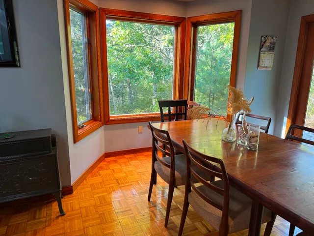 a view of a dining room with furniture and window