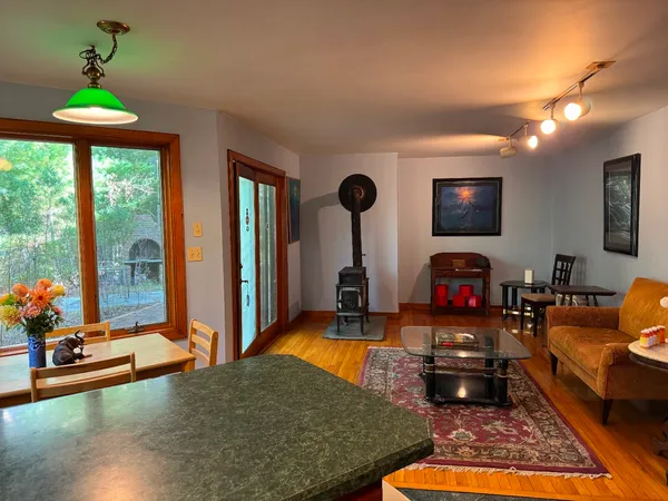 a living room with furniture a rug and a flat screen tv