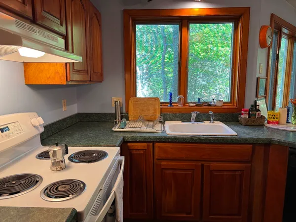 a kitchen with a stove a sink and a refrigerator
