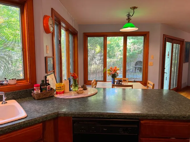 a view of a kitchen with kitchen island granite countertop a large window