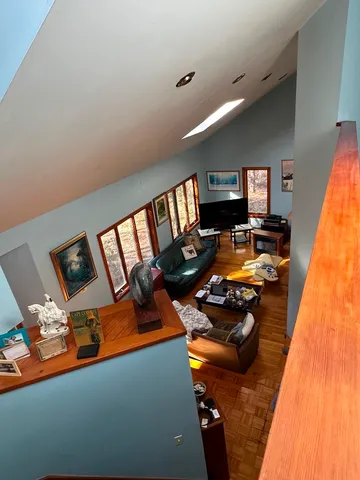 a bed sitting in a bedroom next to a window