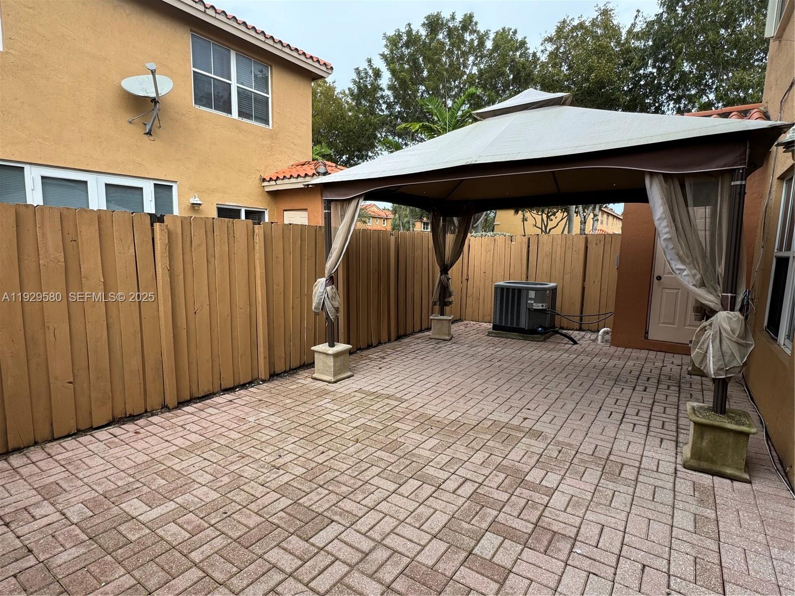 8507 Northwest 140th Terrace, Unit 801 Miami Lakes, FL 33016 - Photo 22 of 42 a backyard of a house with barbeque oven