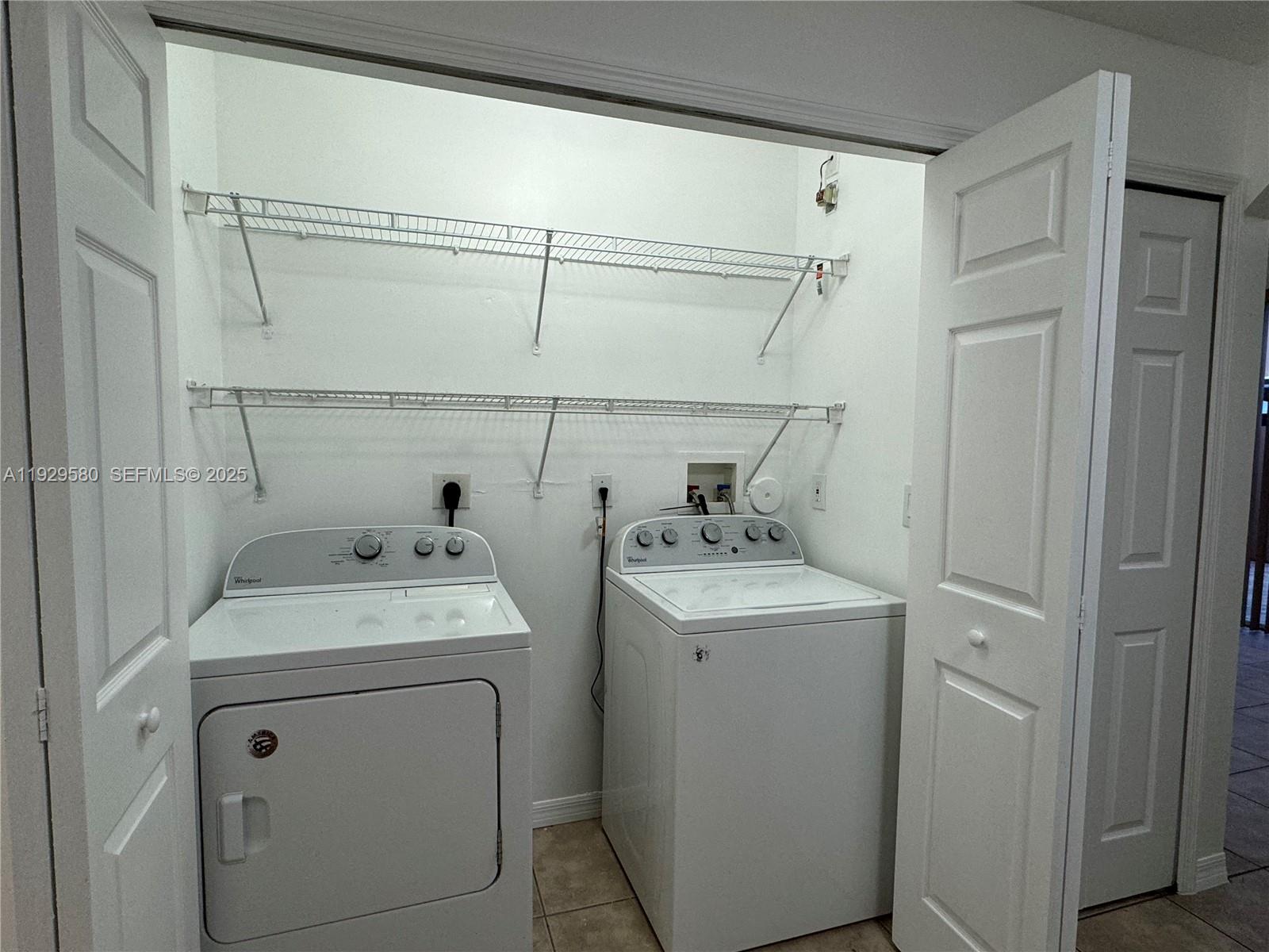 8507 Northwest 140th Terrace, Unit 801 Miami Lakes, FL 33016 - Photo 29 of 42 a utility room with dryer and washer