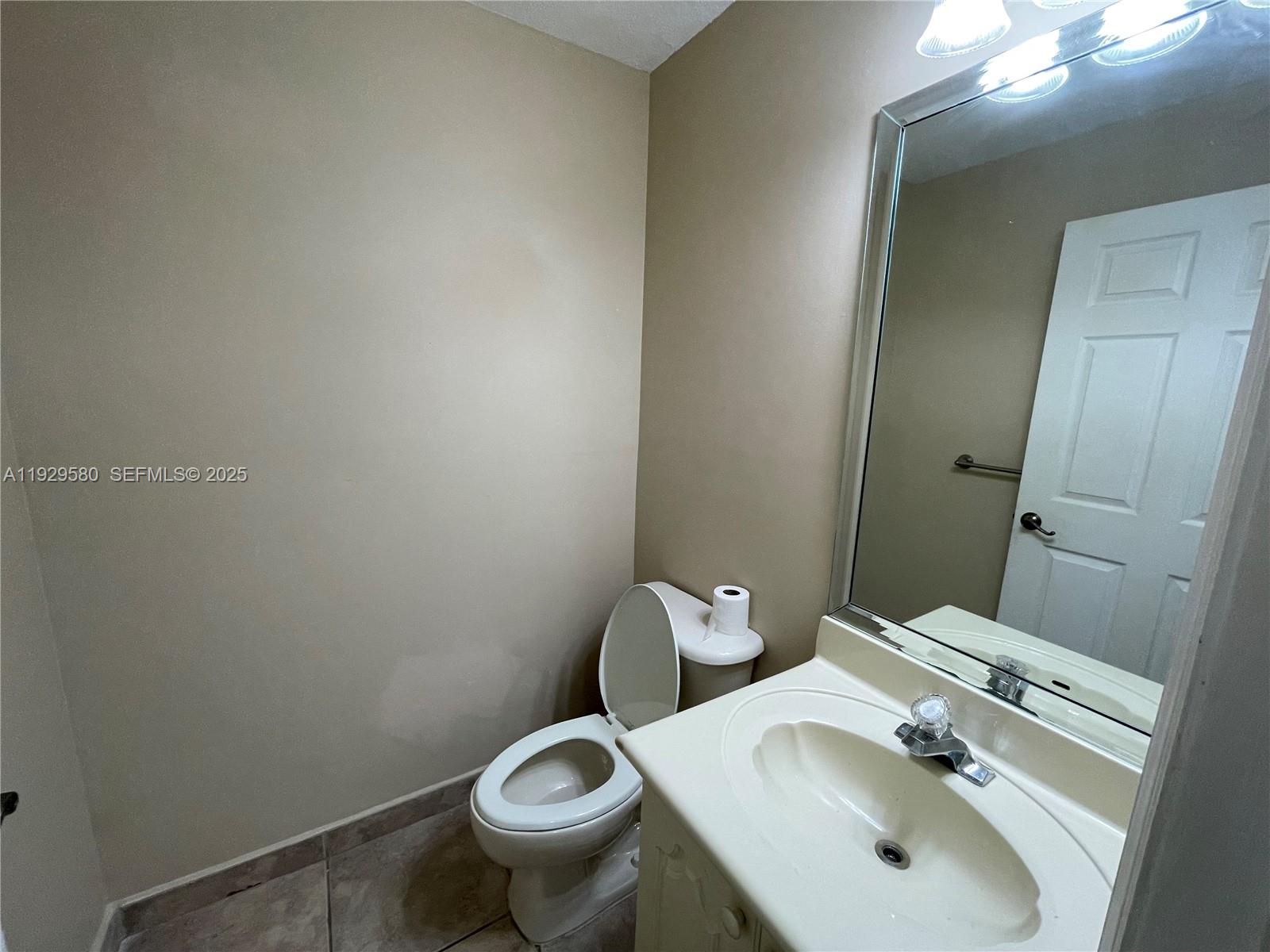 8507 Northwest 140th Terrace, Unit 801 Miami Lakes, FL 33016 - Photo 4 of 42 a bathroom with a sink and toilet