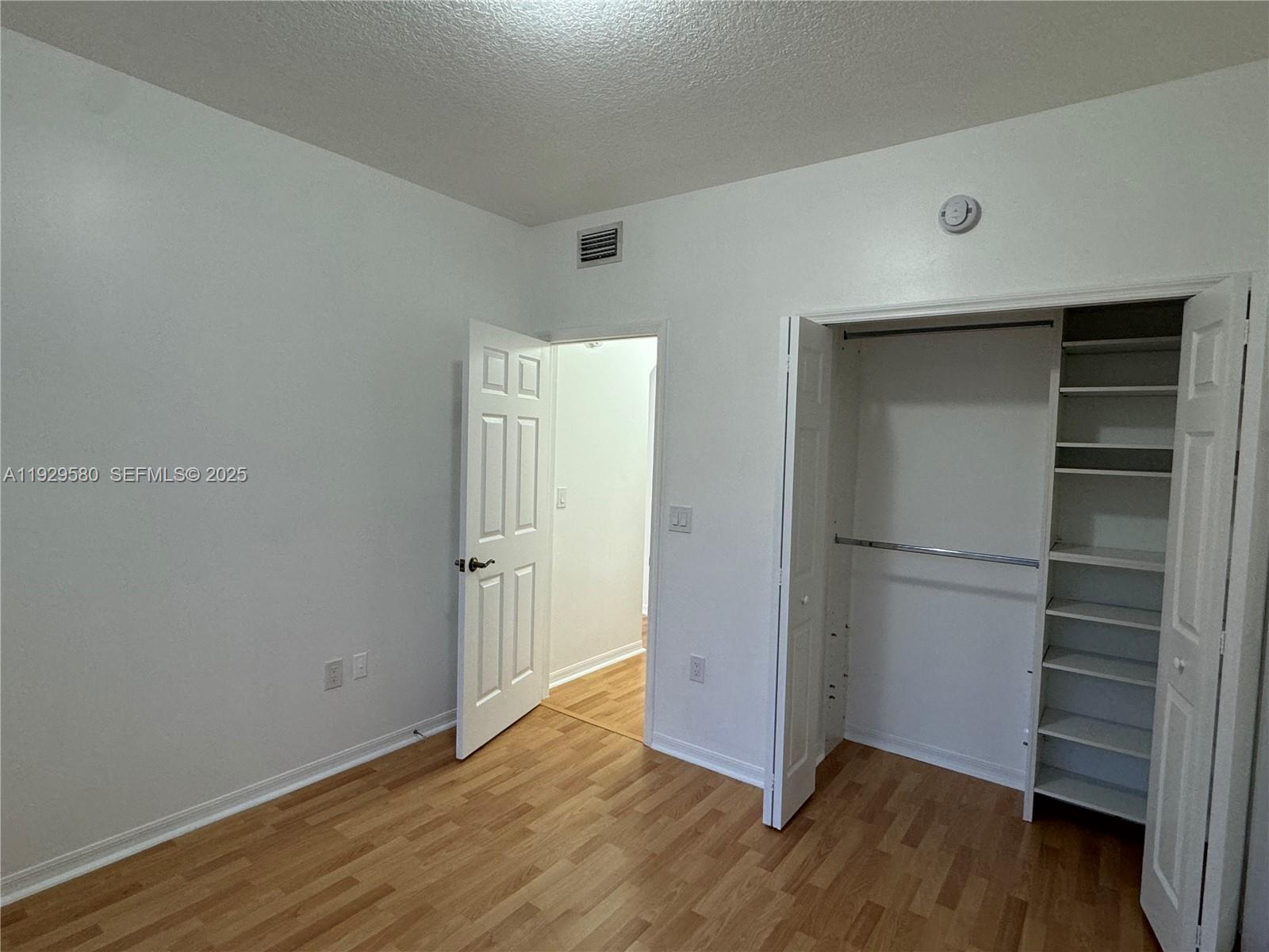 8507 Northwest 140th Terrace, Unit 801 Miami Lakes, FL 33016 - Photo 42 of 42 a view of an empty room with wooden floor