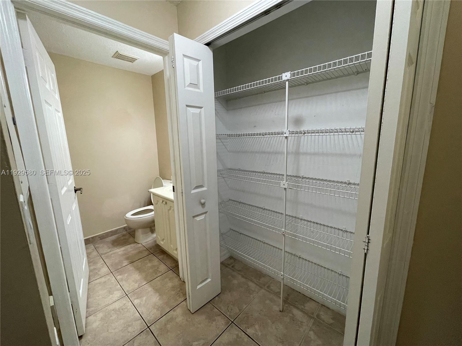 8507 Northwest 140th Terrace, Unit 801 Miami Lakes, FL 33016 - Photo 5 of 42 a bathroom with a toilet and a shower