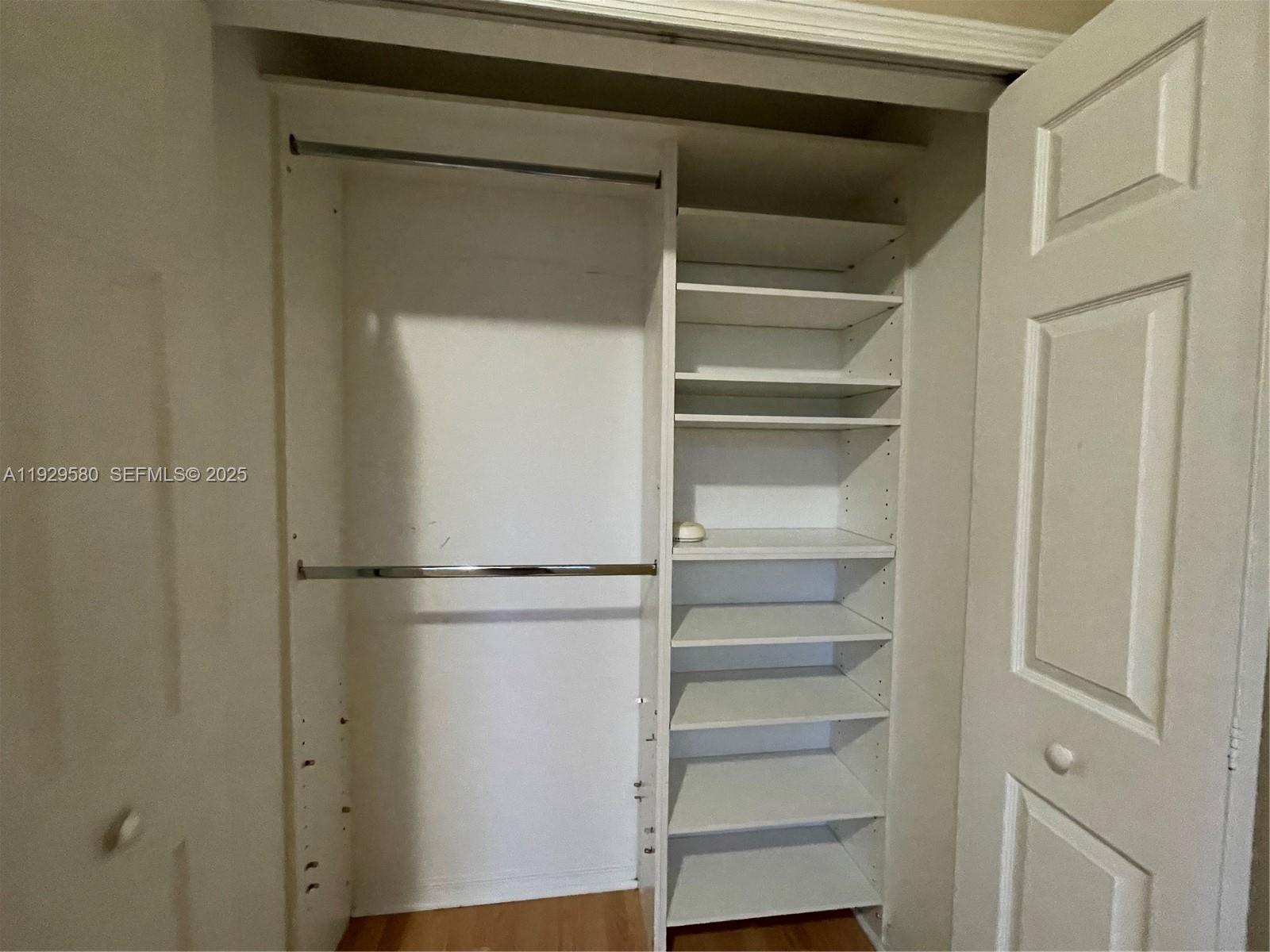 8507 Northwest 140th Terrace, Unit 801 Miami Lakes, FL 33016 - Photo 8 of 42 a view of walk in closet with empty racks