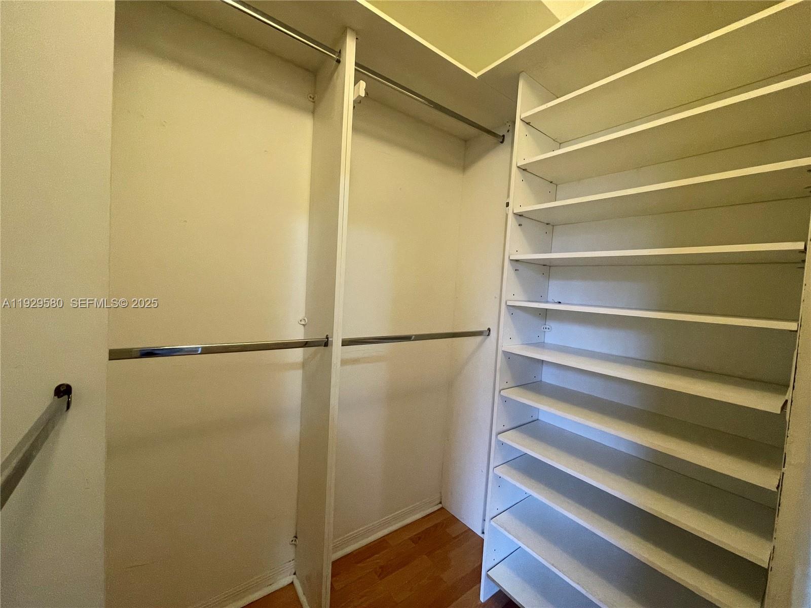 8507 Northwest 140th Terrace, Unit 801 Miami Lakes, FL 33016 - Photo 10 of 42 a view of walk in closet with empty racks