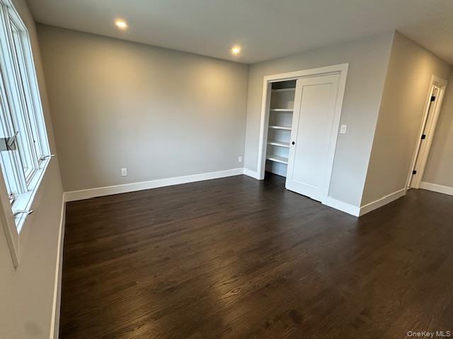 5 Linwood Road North, Unit 2 Port Washington, NY 11050 - Photo 7 of 12 Unfurnished bedroom with dark wood-style flooring, a closet, and recessed lighting