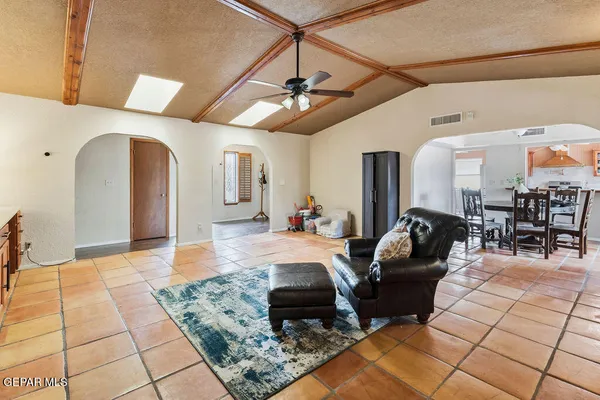 a living room with furniture and a chandelier