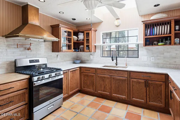 a kitchen with stainless steel appliances granite countertop a stove and a sink