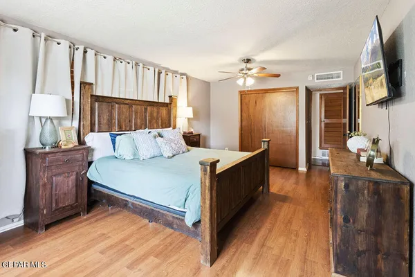 a bed room with a bed window and a television