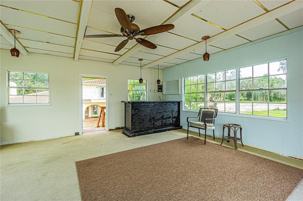 18129 Crawley Road Odessa, FL 33556 - Photo 21 of 38 a living room with furniture a ceiling fan and a window