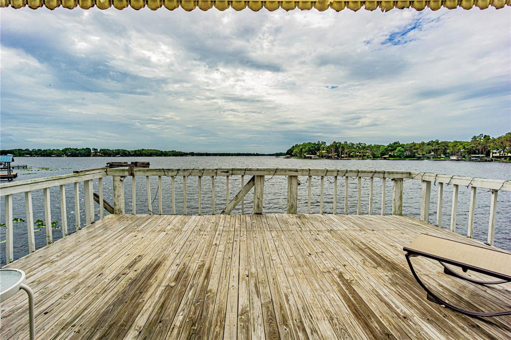 18129 Crawley Road Odessa, FL 33556 - Photo 22 of 38 swimming pool view with lake view and wooden floor