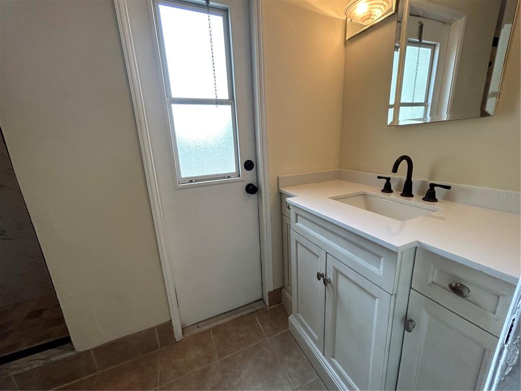 18129 Crawley Road Odessa, FL 33556 - Photo 26 of 38 a bathroom with a sink and a mirror