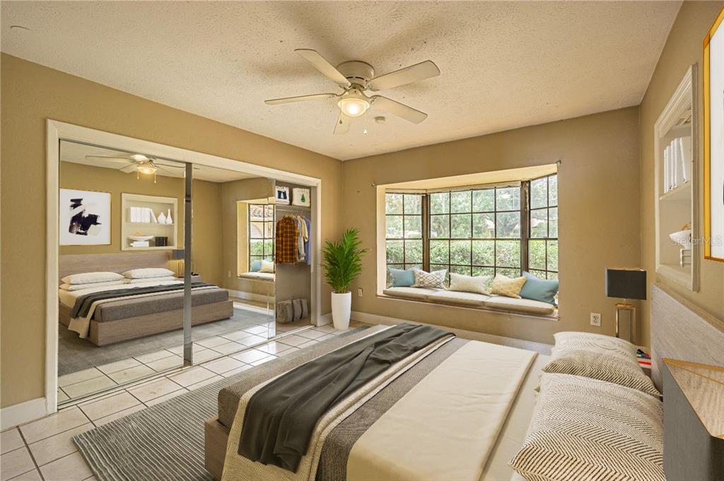 18129 Crawley Road Odessa, FL 33556 - Photo 31 of 38 a bedroom with a bed and a large window with the outer view